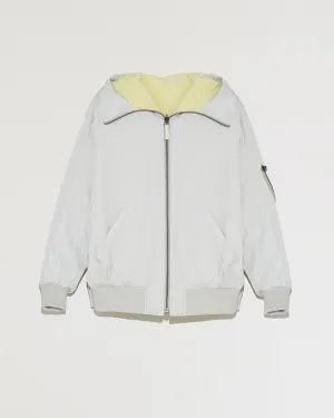 Bomber réversible zippé à capuche en tissu technique et peau lainée